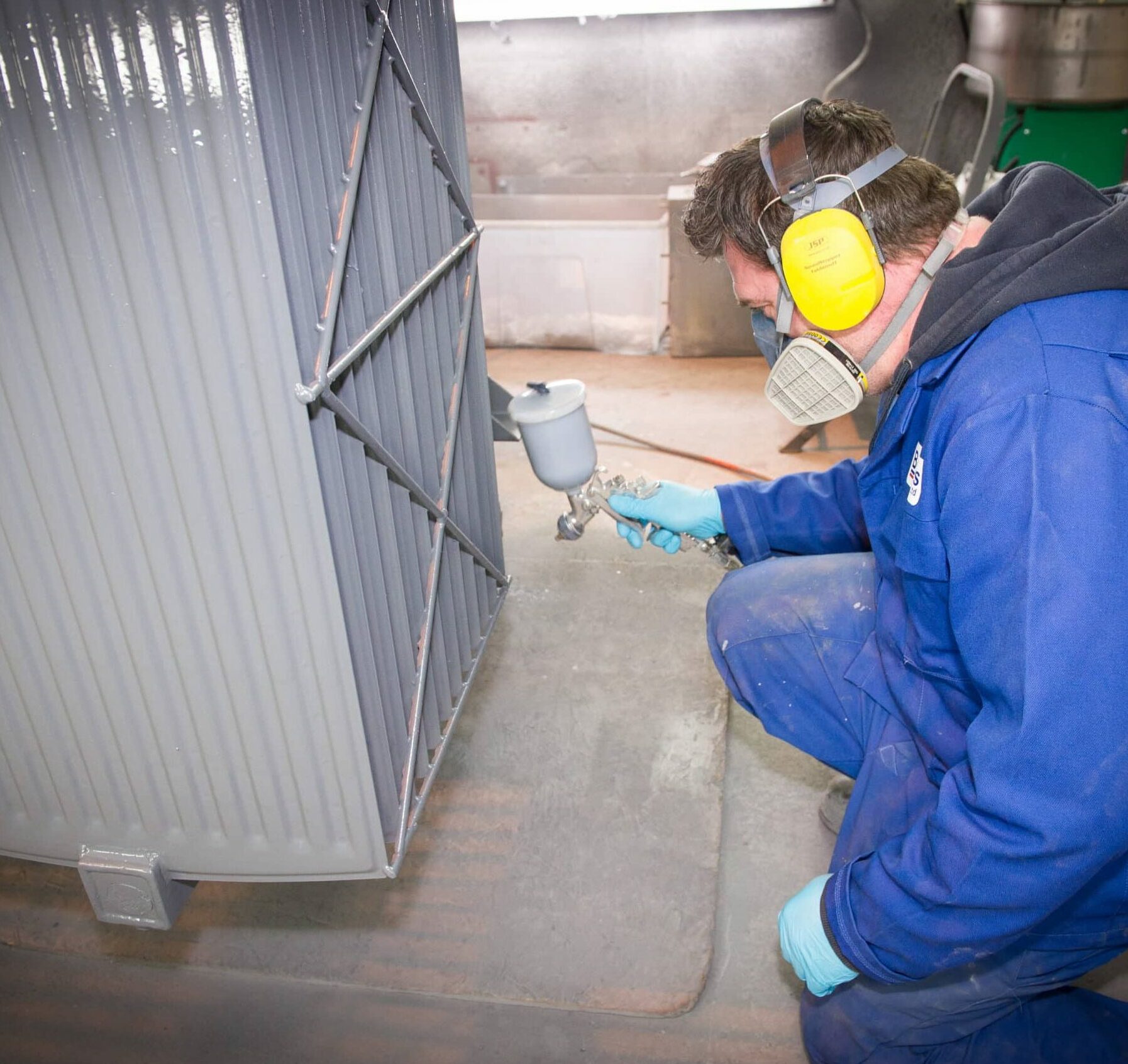 Person spray painting a transformer