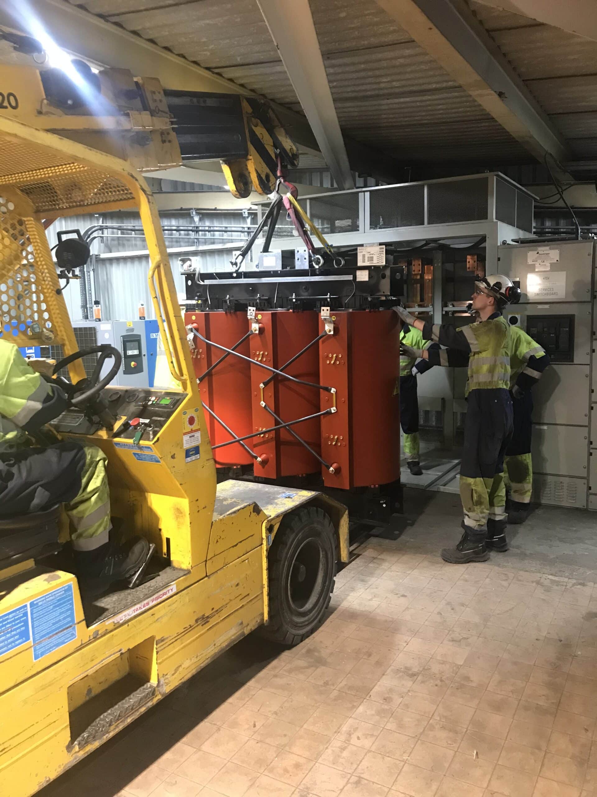 cast resin transformer being lifted into position